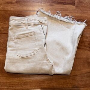 Cream white high-waisted wide leg jeans with frayed hem